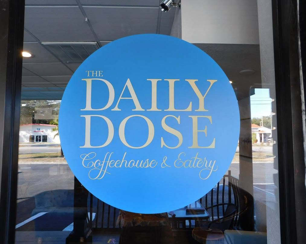 The Daily Dose Coffeehouse and Eatery storefront window signage in Tampa